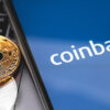 bitcoin, ethereum and smartphone with Coinbase logo on the screen. Coinbase is a digital currency exchange. Moscow, Russia - February 13, 2019